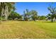 Small storage shed on a large lot with mature trees and green grass provides extra storage space at 1109 Colson Rd, Plant City, FL 33567