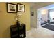 Hallway with wall art and leading to a room featuring carpet flooring and plenty of natural light at 11122 Kempton Vista Dr, Riverview, FL 33579