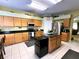 Well-equipped kitchen boasts black granite countertops, modern appliances, and an island at 11122 Kempton Vista Dr, Riverview, FL 33579