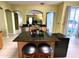 Kitchen island featuring granite countertop with space for seating, near a doorway and sliding glass door at 11122 Kempton Vista Dr, Riverview, FL 33579