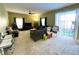 Spacious living room with neutral colors, carpet flooring and sliding glass door to the backyard at 11122 Kempton Vista Dr, Riverview, FL 33579