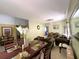 Open-concept living and dining area featuring a chandelier, olive green sofa set, and neutral color scheme at 11122 Kempton Vista Dr, Riverview, FL 33579