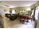 Spacious living room and dining area with chandelier, plush sofas, and natural light at 11122 Kempton Vista Dr, Riverview, FL 33579
