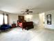 Bright main bedroom with carpet flooring, a seating area, a ceiling fan, and neutral walls at 11122 Kempton Vista Dr, Riverview, FL 33579