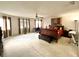 Spacious main bedroom featuring a ceiling fan, carpeted floors, and many windows for natural light at 11122 Kempton Vista Dr, Riverview, FL 33579