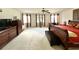 A large main bedroom showing carpet flooring, windows, and a ceiling fan at 11122 Kempton Vista Dr, Riverview, FL 33579