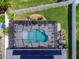 Overhead shot of a private screened pool, surrounded by well-maintained landscaping and a secure fenced yard at 11219 Paddock Manor Ave, Riverview, FL 33569