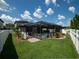 Aerial backyard view showcases a screened pool, privacy fence, lush grass, and thoughtful landscaping at 11219 Paddock Manor Ave, Riverview, FL 33569