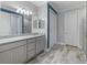 Bathroom features a granite countertop vanity, tile flooring and a large mirror at 11219 Paddock Manor Ave, Riverview, FL 33569