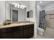 Bathroom features granite countertops, wood cabinets, and a shower-tub combination at 11219 Paddock Manor Ave, Riverview, FL 33569