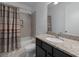 Bathroom featuring granite countertop, dark wood cabinets, and a shower-tub combination at 11219 Paddock Manor Ave, Riverview, FL 33569
