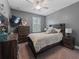 Bedroom featuring carpet, a ceiling fan, natural light, and wood furnishings at 11219 Paddock Manor Ave, Riverview, FL 33569