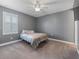 Bedroom with plush carpet, grey walls and bedding, and a ceiling fan at 11219 Paddock Manor Ave, Riverview, FL 33569