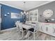 A dining room with a white table and chairs, a chandelier, and light-colored flooring at 11219 Paddock Manor Ave, Riverview, FL 33569