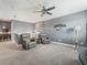 A gray living room with a ceiling fan and two leather recliners at 11219 Paddock Manor Ave, Riverview, FL 33569