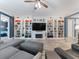 Elegant living room featuring built-in bookshelves, a fireplace, and modern furniture at 11219 Paddock Manor Ave, Riverview, FL 33569