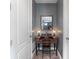 Charming office nook featuring an antique wooden desk and chair between two white paneled doors at 11219 Paddock Manor Ave, Riverview, FL 33569