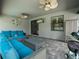 Comfortable outdoor patio with grill, ceiling fans, and plush blue seating at 11219 Paddock Manor Ave, Riverview, FL 33569