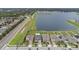 An aerial view of a neighborhood featuring a lake, sidewalks, and neatly manicured lawns at 11308 Chilly Water Ct, Riverview, FL 33569