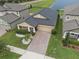 Beautiful aerial view of the home showcasing its well-maintained lawn, landscaping, and brick driveway at 11308 Chilly Water Ct, Riverview, FL 33569
