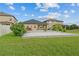 Large backyard featuring a well-maintained lawn and an inviting patio for outdoor enjoyment and relaxation at 11308 Chilly Water Ct, Riverview, FL 33569