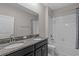 Bathroom featuring a double sink vanity with granite countertop and a shower/tub with tiled walls at 11308 Chilly Water Ct, Riverview, FL 33569