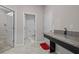 Bathroom featuring gray tile floors, granite countertop, walk-in shower, and bath tub at 11308 Chilly Water Ct, Riverview, FL 33569