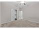 Bedroom features a ceiling fan, closet, and a doorway to another room, complemented by carpeted floors at 11308 Chilly Water Ct, Riverview, FL 33569