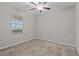 Bedroom with a ceiling fan, neutral colored walls and carpet, and a window offering natural light at 11308 Chilly Water Ct, Riverview, FL 33569
