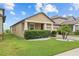 View of home's side exterior and well-manicured lawn with desert landscaping at 11308 Chilly Water Ct, Riverview, FL 33569