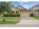 Charming house with a brick driveway, well-maintained lawn, and desert landscaping at 11308 Chilly Water Ct, Riverview, FL 33569