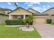 Charming house with a brick driveway, well-maintained lawn, desert landscaping, and neutral colors at 11308 Chilly Water Ct, Riverview, FL 33569