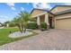 Home's front porch featuring desert landscaping with neutral exterior paint colors at 11308 Chilly Water Ct, Riverview, FL 33569