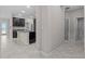 View of the kitchen showing dark cabinets and countertops, stainless steel refrigerator, and tile floors at 11308 Chilly Water Ct, Riverview, FL 33569