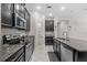 Modern kitchen featuring stainless steel appliances, dark cabinetry, and granite countertops at 11308 Chilly Water Ct, Riverview, FL 33569