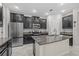 Modern kitchen featuring stainless steel appliances, dark cabinetry, and granite countertops at 11308 Chilly Water Ct, Riverview, FL 33569