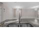 Kitchen island with granite countertop and sink overlooks adjacent open living area at 11308 Chilly Water Ct, Riverview, FL 33569