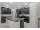 Modern kitchen features dark wood cabinets, granite countertops, and stainless steel appliances at 11308 Chilly Water Ct, Riverview, FL 33569