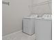 Functional laundry room features a modern washer, dryer, and convenient overhead shelving at 11308 Chilly Water Ct, Riverview, FL 33569