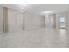 Expansive living room featuring tile flooring, neutral walls, modern lighting, and natural light at 11308 Chilly Water Ct, Riverview, FL 33569