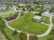 Aerial view of a neighborhood park featuring a playground, picnic area and fenced dog park at 11308 Chilly Water Ct, Riverview, FL 33569