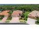 Aerial view of a well-maintained single-Gathering home with a three-car garage and mature landscaping at 11343 Dancing River Dr, Venice, FL 34292