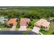 Aerial view of a well-maintained single-Gathering home with a three-car garage and mature landscaping at 11343 Dancing River Dr, Venice, FL 34292