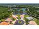 Aerial view of a well-maintained single-Gathering home with a pool, three-car garage and mature landscaping at 11343 Dancing River Dr, Venice, FL 34292