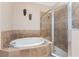 Bright bathroom featuring a soaking tub and a walk-in shower at 11343 Dancing River Dr, Venice, FL 34292