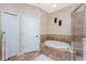 Bright bathroom featuring a soaking tub and a walk-in shower at 11343 Dancing River Dr, Venice, FL 34292
