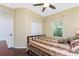 Comfortable bedroom with wood floors, soft bedding, ceiling fan and natural light from the window at 11343 Dancing River Dr, Venice, FL 34292