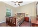 Relaxing bedroom features a bed with patterned bedding, side tables with lamps, and hardwood flooring at 11343 Dancing River Dr, Venice, FL 34292