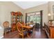 Elegant dining area featuring wood floors, a large china cabinet, and views of the screened patio at 11343 Dancing River Dr, Venice, FL 34292