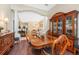 Dining area with wood flooring, stylish china cabinet, and natural light flowing in at 11343 Dancing River Dr, Venice, FL 34292